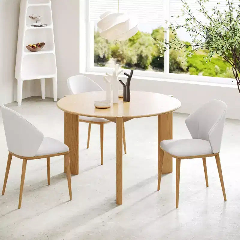 Table de salle à manger de ferme en bois massif avec plateau rond en bois texturé et piètement en X pour salles à manger modernes et réunions de famille