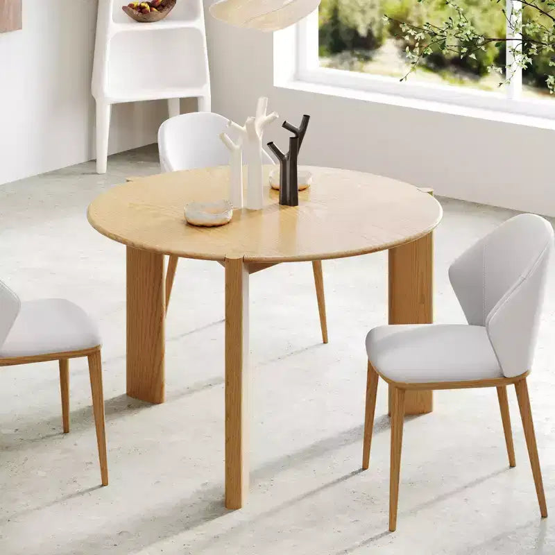 Table de salle à manger de ferme en bois massif avec plateau rond en bois texturé et piètement en X pour salles à manger modernes et réunions de famille